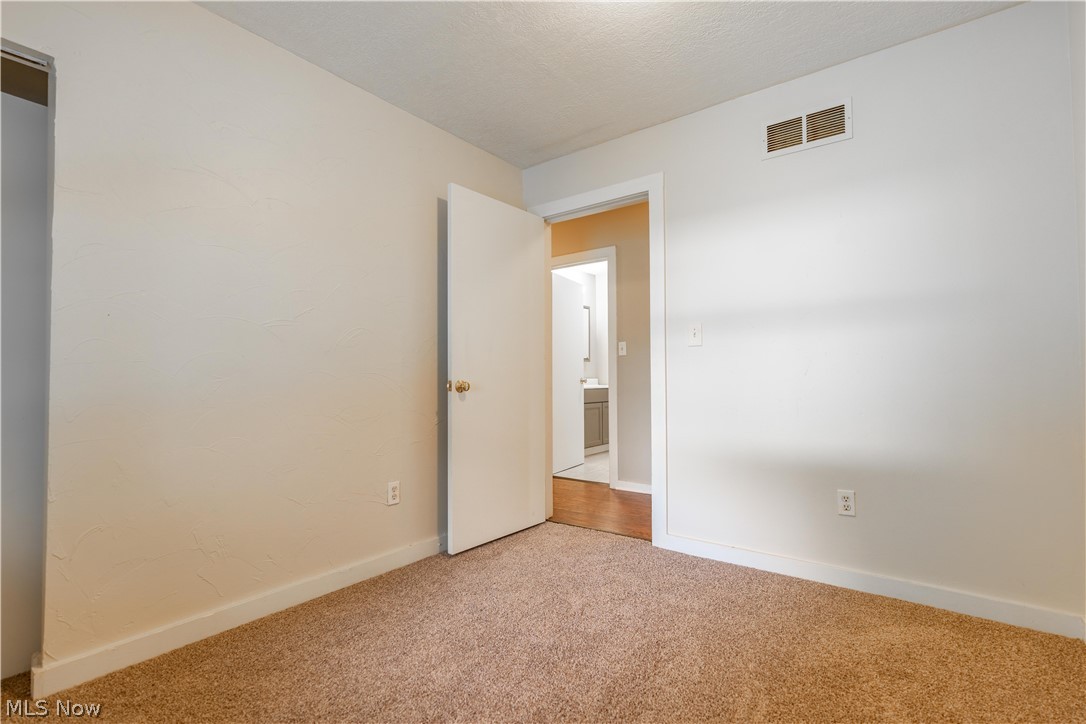 1889 Ronald Road Akron, OH 44312 - Photo 24 of 36 Spare room with light colored carpet