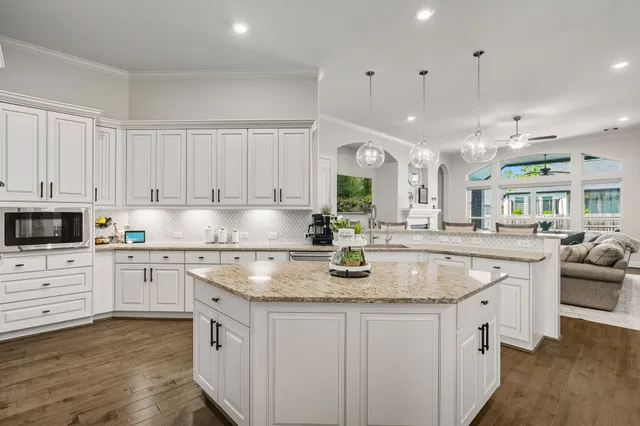 a kitchen with stainless steel appliances granite countertop a sink stove and cabinets