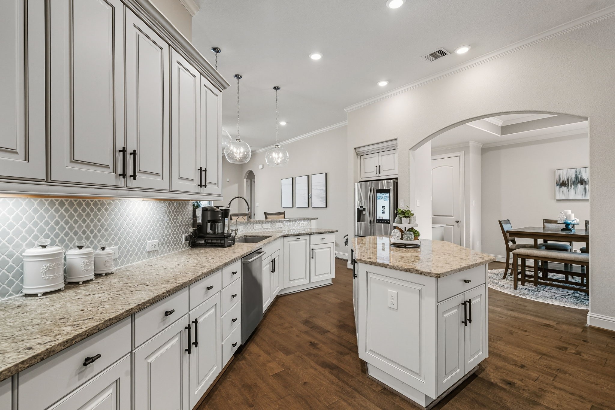 2008 Green Terrace Lane Pinehurst, TX 77362 - Photo 16 of 47 Lots of lighting and high ceilings make the kitchen bright and inviting. Crown molding, granite countertops, and under cabinet lighting helps make this kitchen a chef's favorite room in the house.