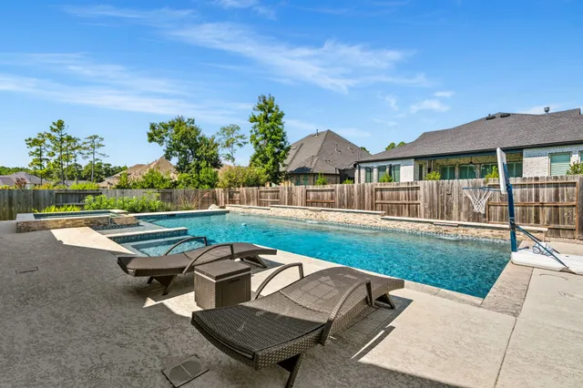 a view of a house with a yard and lake
