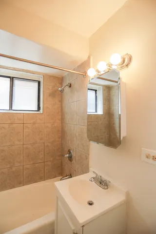 a bathroom with a sink a mirror and a bathtub