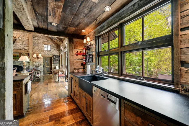 a living room with furniture fireplace and large windows