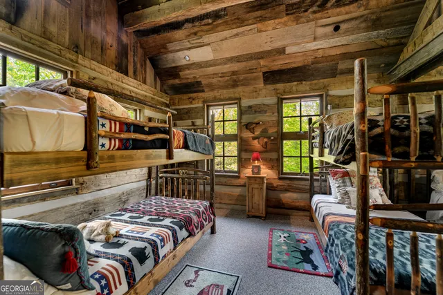 a view of a patio with table and chairs potted plants and floor to ceiling window