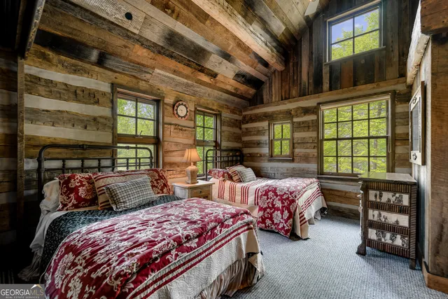 a view of a patio with table and chairs potted plants and large tree