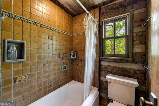 a view of a lake with a bench and trees around