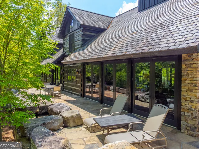 a view of a house with backyard porch and sitting area