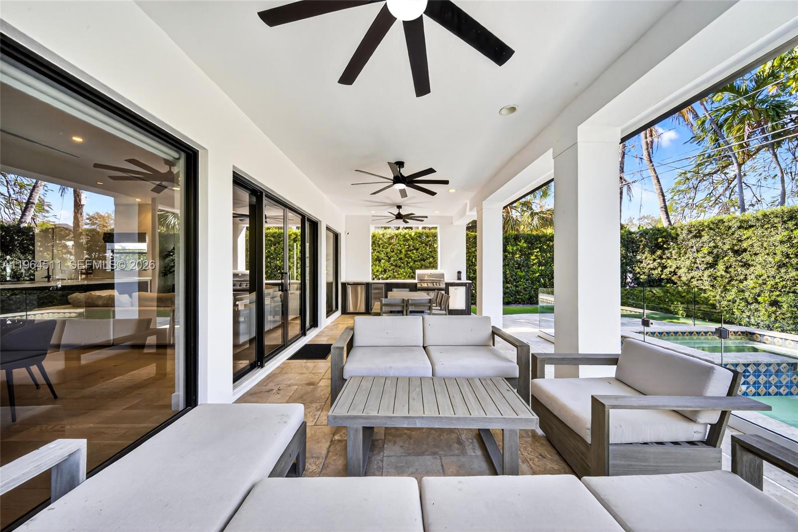 7500 Southwest 55th Avenue Miami, FL 33143 - Photo 24 of 48 a living room with furniture large windows and wooden floor