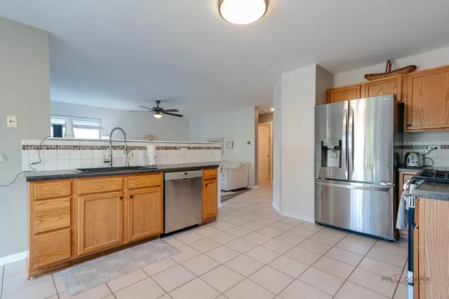 a kitchen with granite countertop cabinets stainless steel appliances and a counter space