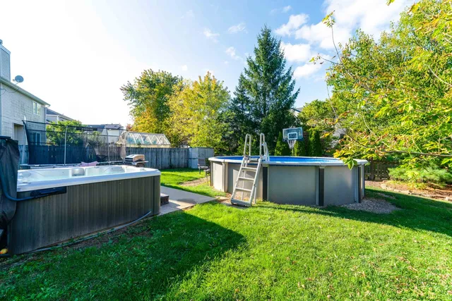 a view of a backyard with a garden and fire pit
