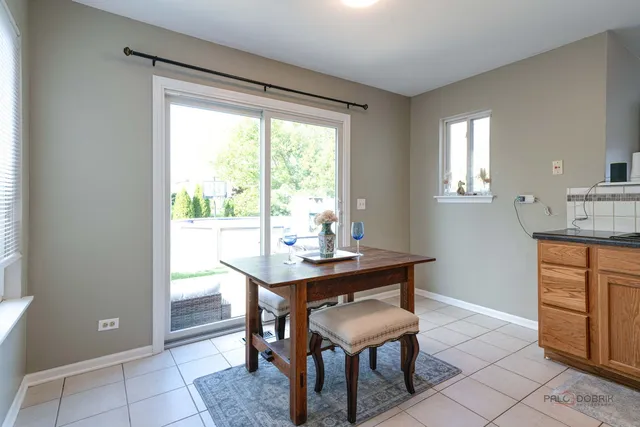 a view of a dining room with a table and chairs