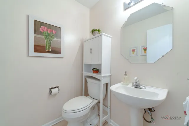 a bathroom with a sink mirror and toilet