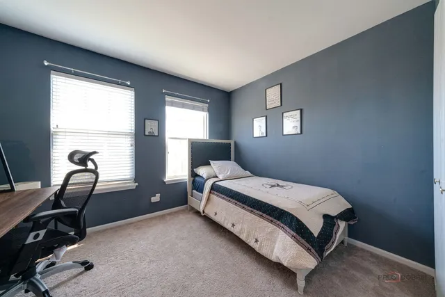 a bedroom with a bed and windows