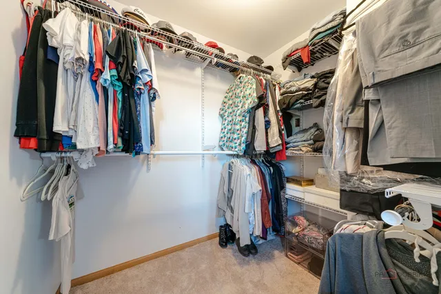 a view of walk in closet with clothes