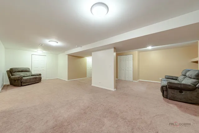 a living room with furniture a couch and a potted plant