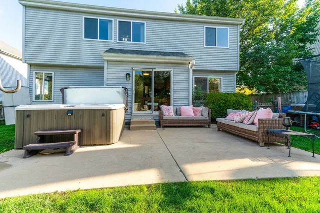 a view of a house with a patio and a yard