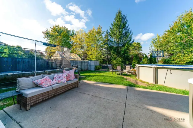 a view of backyard with seating and green space