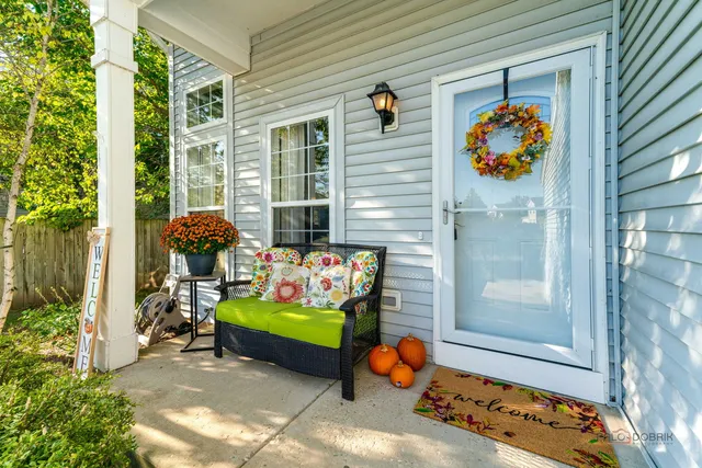 a view of front door of house with outdoor seating space