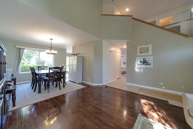 a view of a a dining room with furniture and fan chandelier