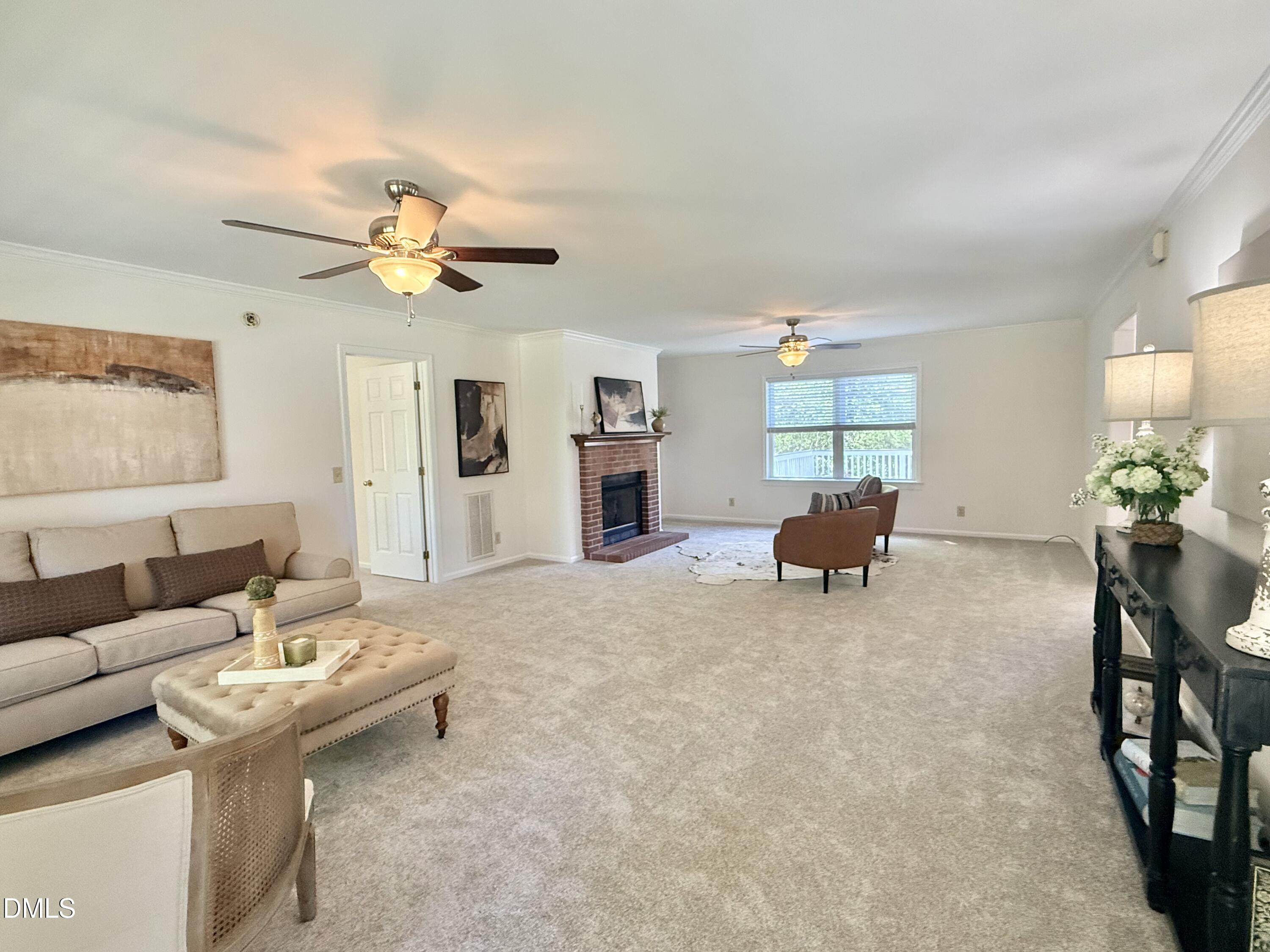 2429 Halifax Road Roxboro, NC 27573 - Photo 10 of 54 a living room with furniture and a chandelier