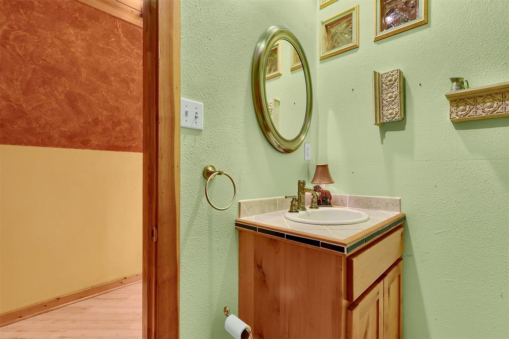 263 Rio Roxo Road Gordonville, TX 76245 - Photo 33 of 33 Bathroom featuring hardwood / wood-style flooring and vanity
