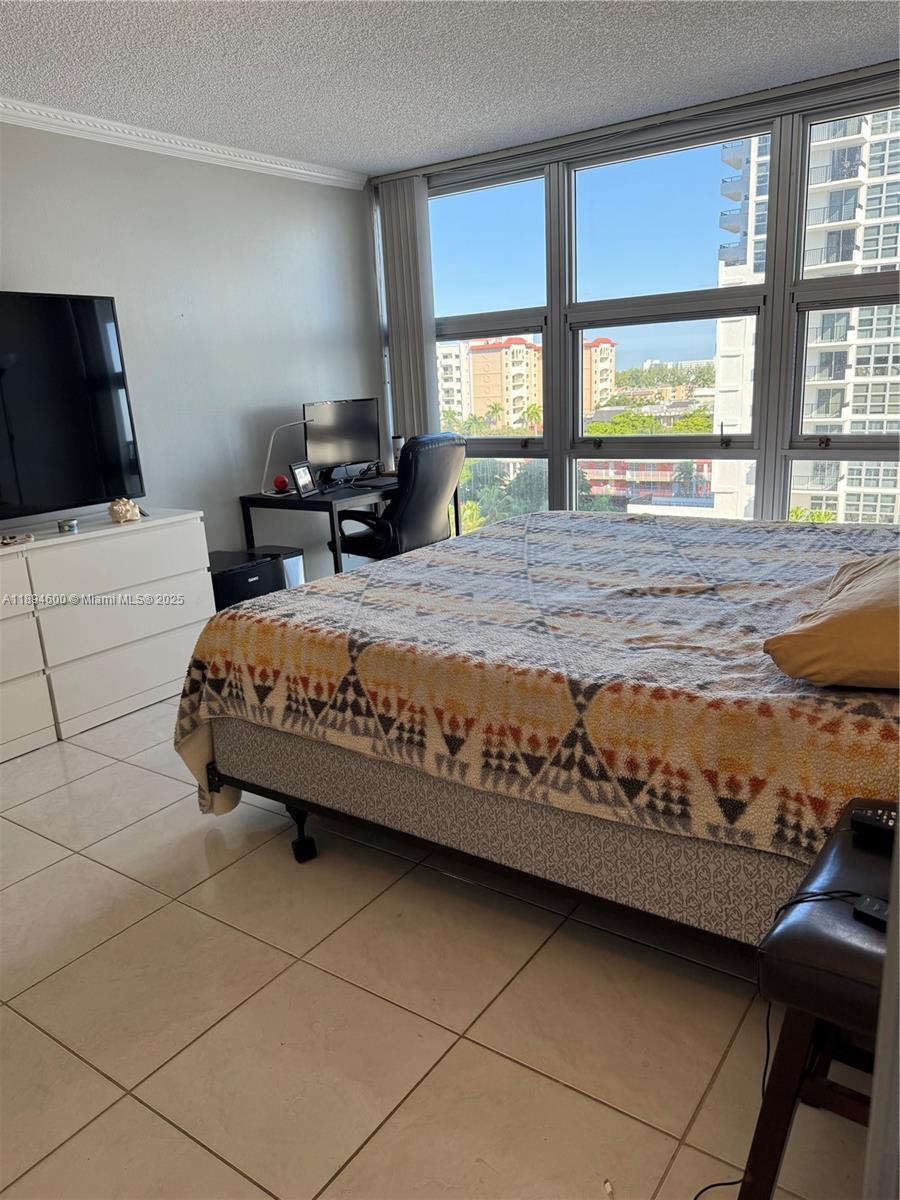 525 North Ocean Boulevard, Unit 920 Pompano Beach, FL 33062 - Photo 16 of 38 a bedroom with a bed and a large window