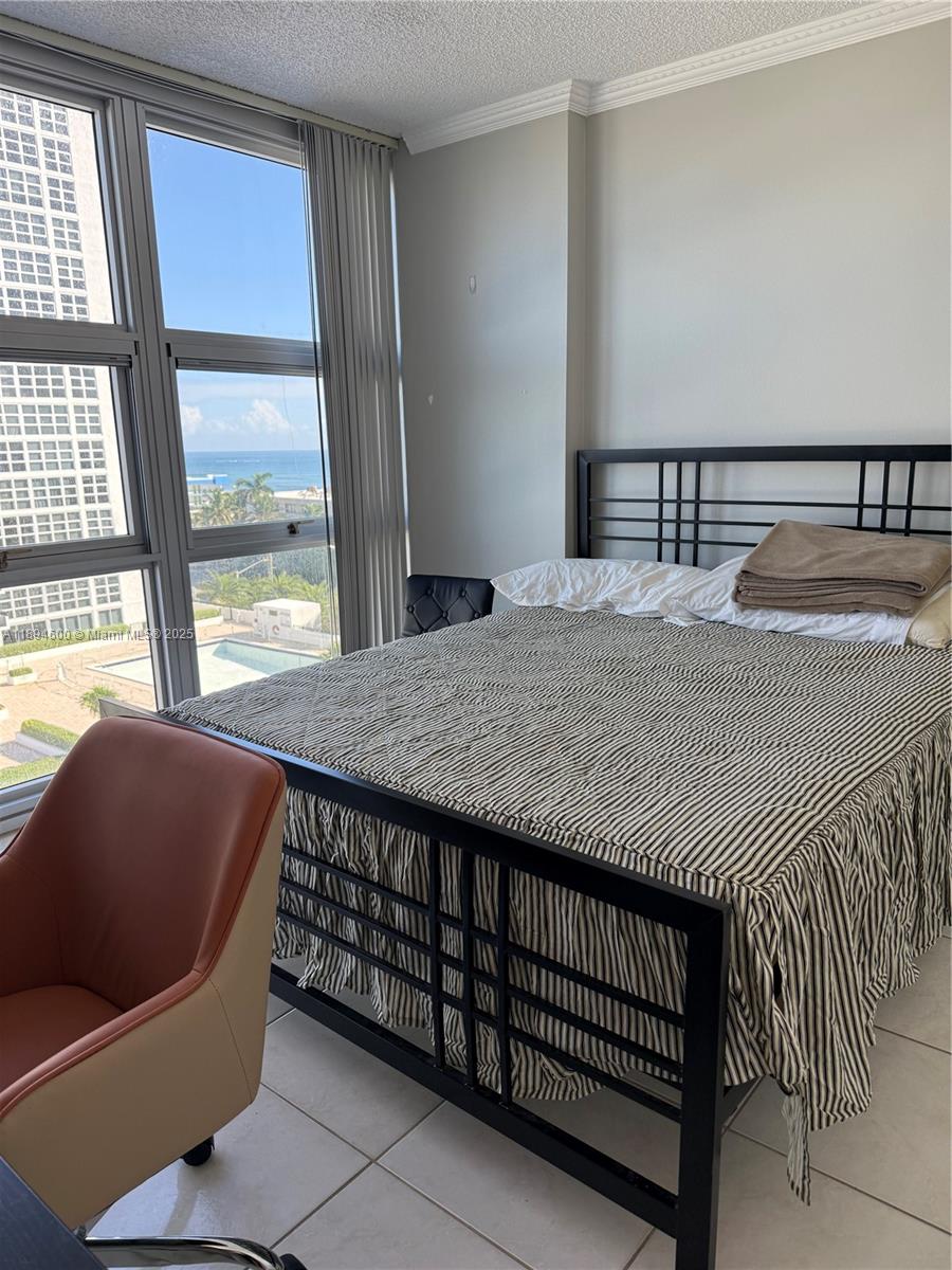 525 North Ocean Boulevard, Unit 920 Pompano Beach, FL 33062 - Photo 20 of 38 a bed sitting in a bedroom next to a window