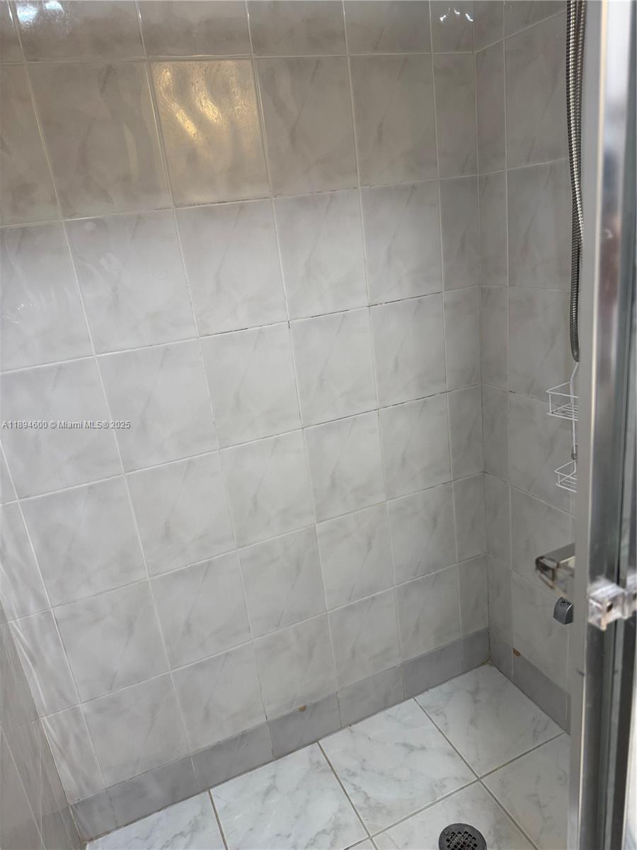 525 North Ocean Boulevard, Unit 920 Pompano Beach, FL 33062 - Photo 22 of 38 a bathroom with a glass shower door