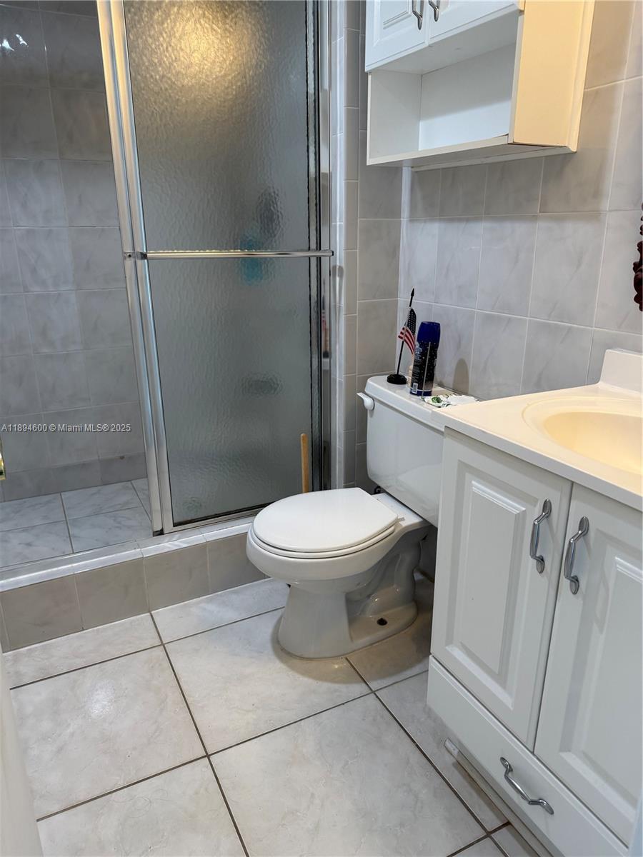 525 North Ocean Boulevard, Unit 920 Pompano Beach, FL 33062 - Photo 24 of 38 a bathroom with a toilet and a shower