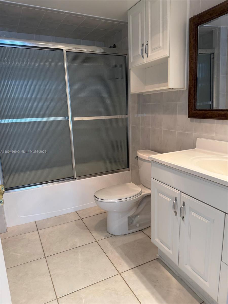 525 North Ocean Boulevard, Unit 920 Pompano Beach, FL 33062 - Photo 36 of 38 a bathroom with a toilet a sink and shower