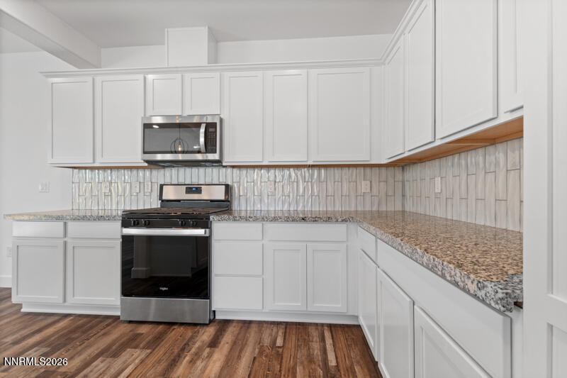 2020 Cradle Mountain Drive, Unit 3 Reno, NV 89523 - Photo 15 of 29 a kitchen with stainless steel appliances granite countertop a stove and a sink