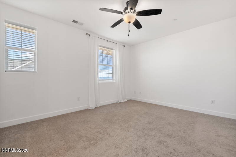 2020 Cradle Mountain Drive, Unit 3 Reno, NV 89523 - Photo 20 of 29 an empty room with windows and fan