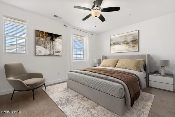 a bedroom with a bed and a chair