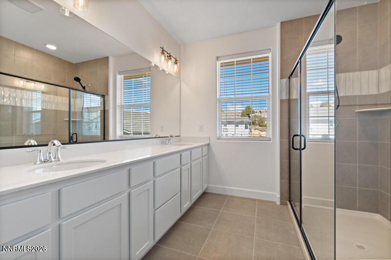 2020 Cradle Mountain Drive, Unit 3 Reno, NV 89523 - Photo 22 of 29 a spacious bathroom with double vanity and a mirror