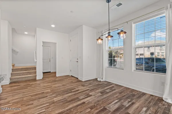 a view of a room with wooden floor and windows