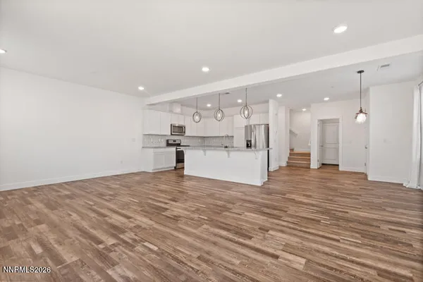 a view of a kitchen with a sink and a refrigerator