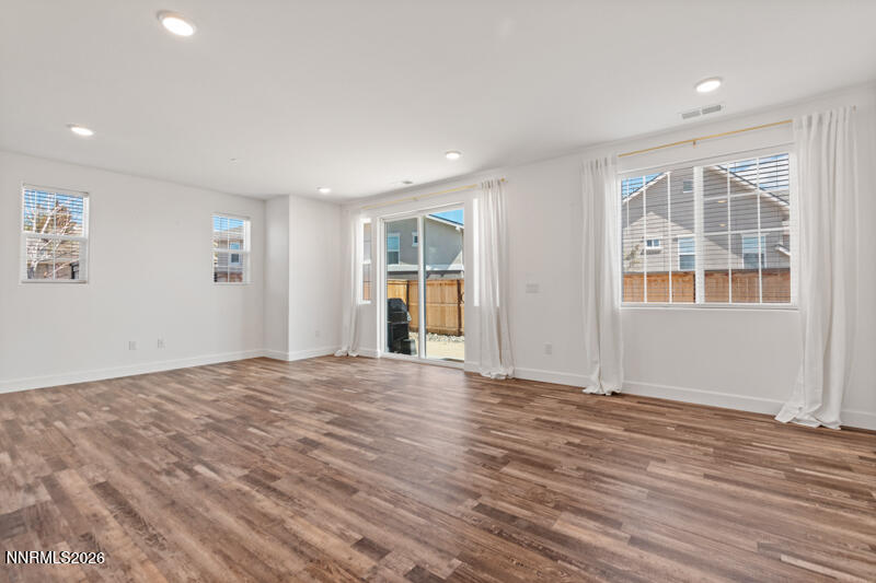 2020 Cradle Mountain Drive, Unit 3 Reno, NV 89523 - Photo 10 of 29 a view of an empty room with wooden floor and windows