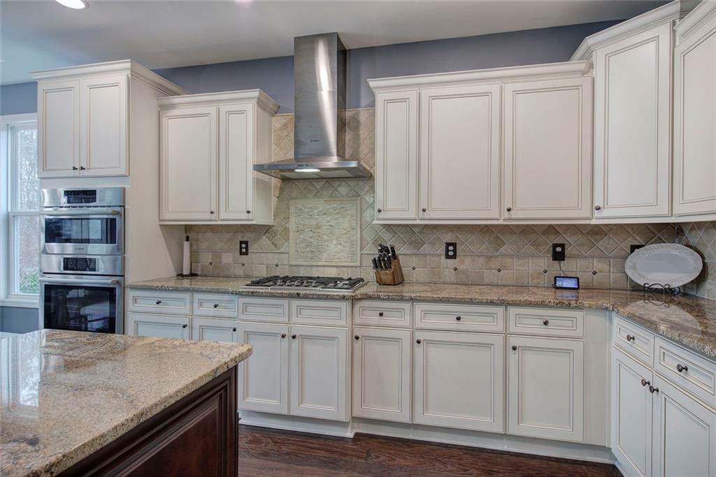 18 Weather View Trail Cartersville, GA 30121 - Photo 11 of 78 a kitchen with granite countertop white cabinets and stainless steel appliances