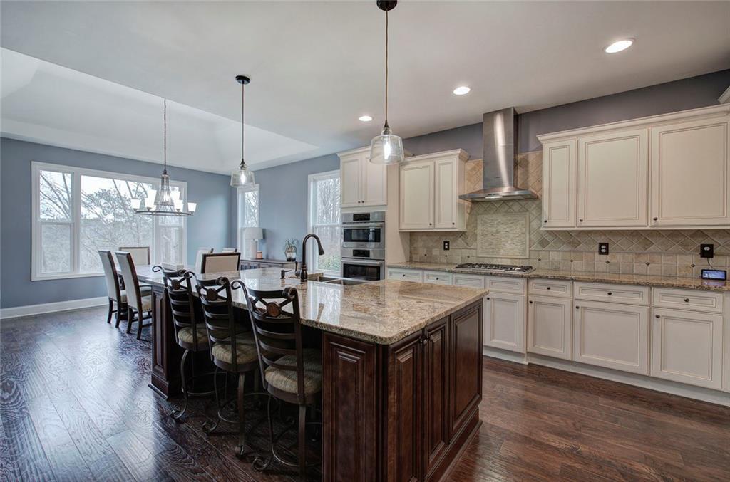 18 Weather View Trail Cartersville, GA 30121 - Photo 12 of 78 a kitchen with stainless steel appliances granite countertop a kitchen island a stove a table and chairs in it