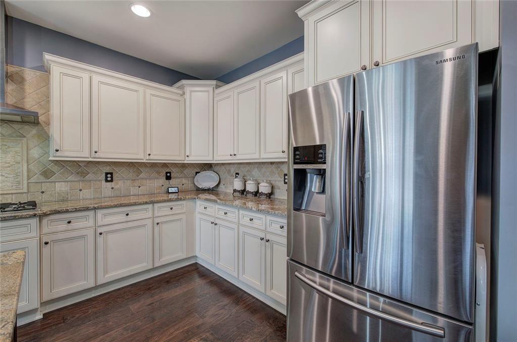 18 Weather View Trail Cartersville, GA 30121 - Photo 13 of 78 a kitchen with stainless steel appliances granite countertop a refrigerator sink and white cabinets