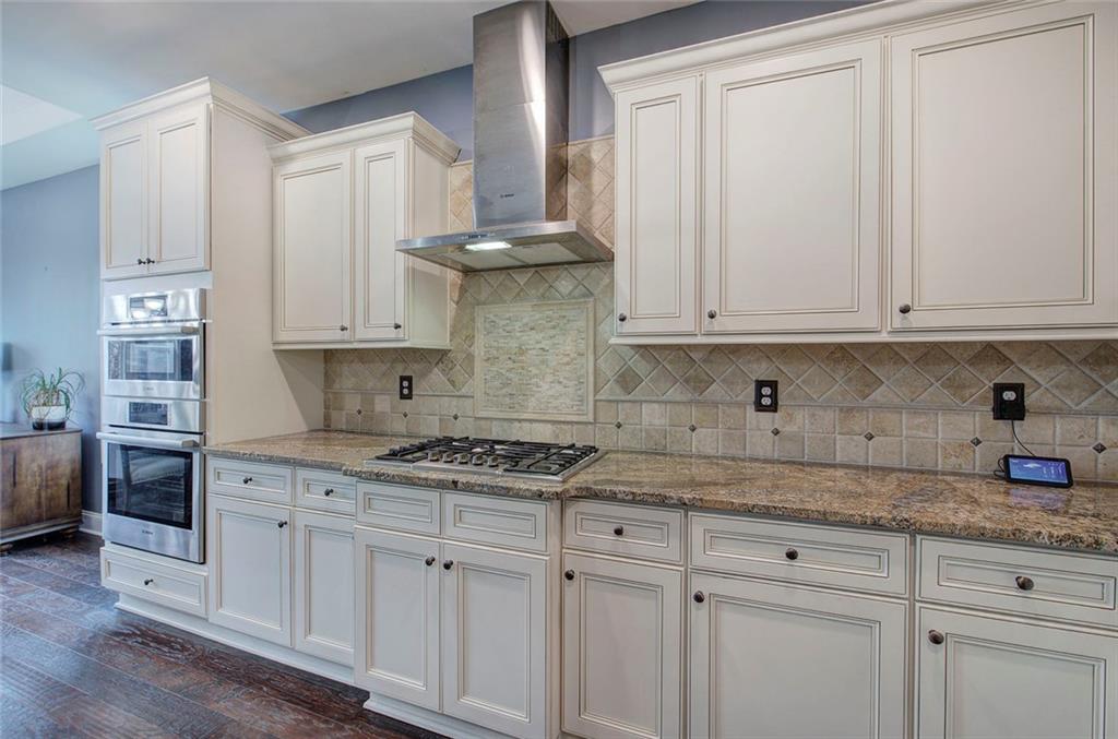 18 Weather View Trail Cartersville, GA 30121 - Photo 14 of 78 a kitchen with granite countertop white cabinets and stainless steel appliances