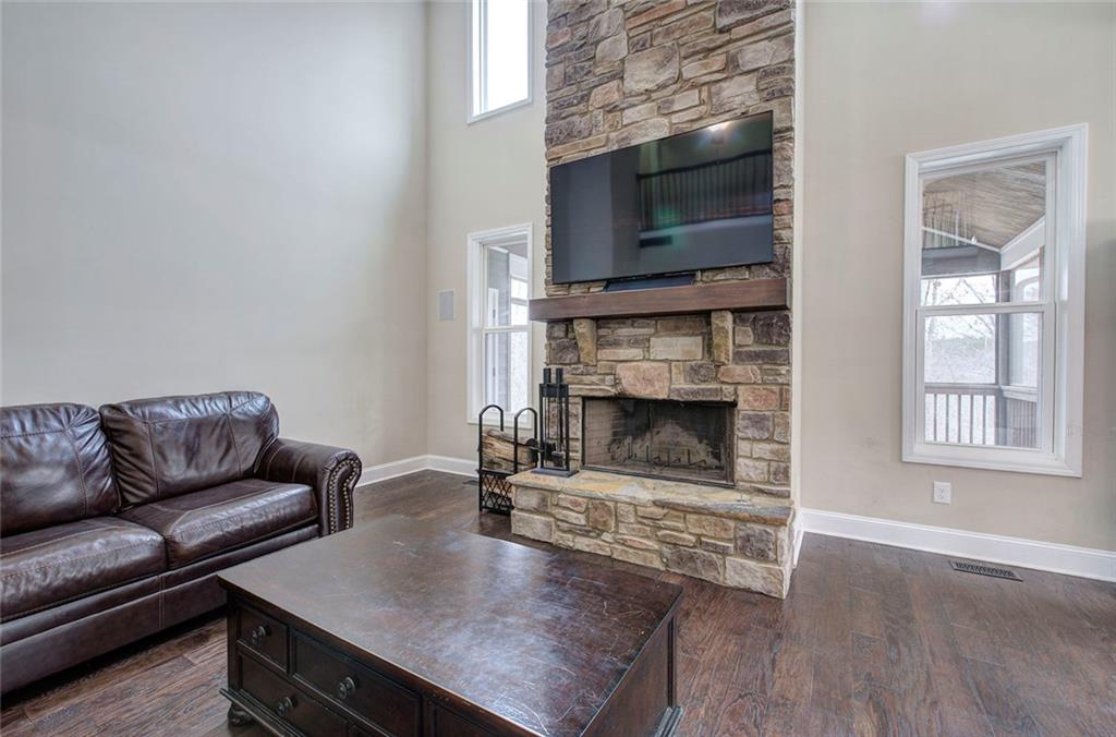 18 Weather View Trail Cartersville, GA 30121 - Photo 21 of 78 a living room with furniture a flat screen tv and a fireplace
