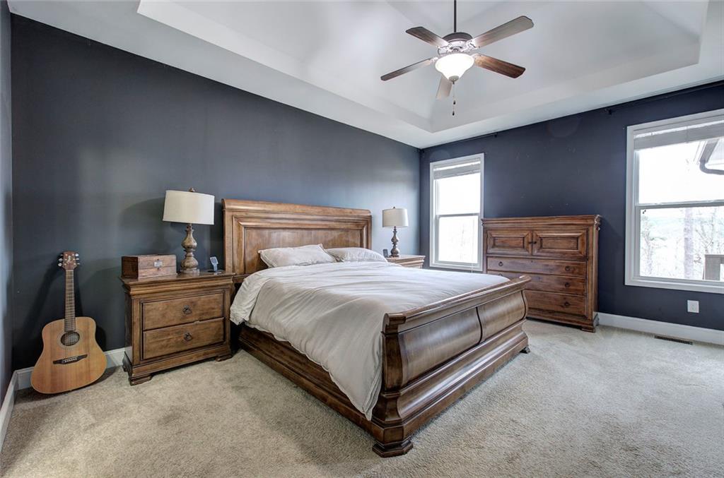 18 Weather View Trail Cartersville, GA 30121 - Photo 27 of 78 a spacious bedroom with a bed and a chandelier