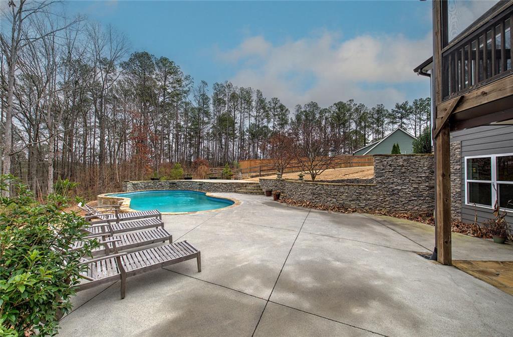 18 Weather View Trail Cartersville, GA 30121 - Photo 66 of 78 a view of a bench with fire pit and trees in front of main door