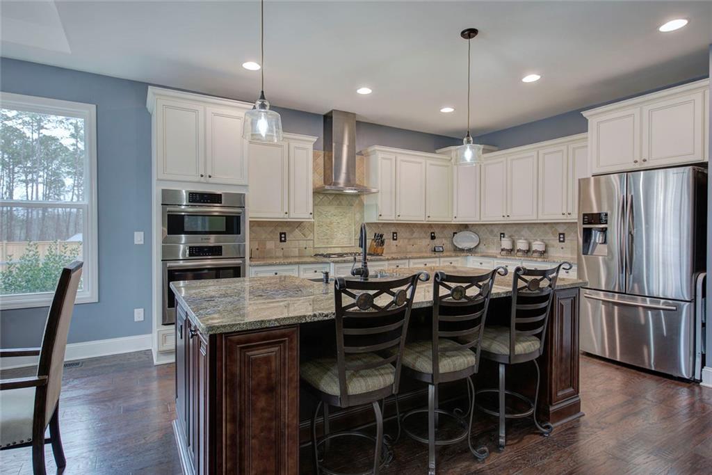 18 Weather View Trail Cartersville, GA 30121 - Photo 8 of 78 a kitchen with granite countertop a center island and stainless steel appliances