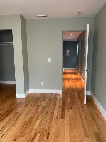 wooden floor in an empty room with a gallery