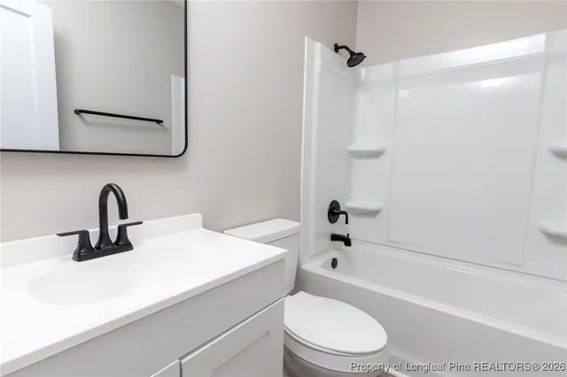 a bathroom with a sink a toilet and a bathtub