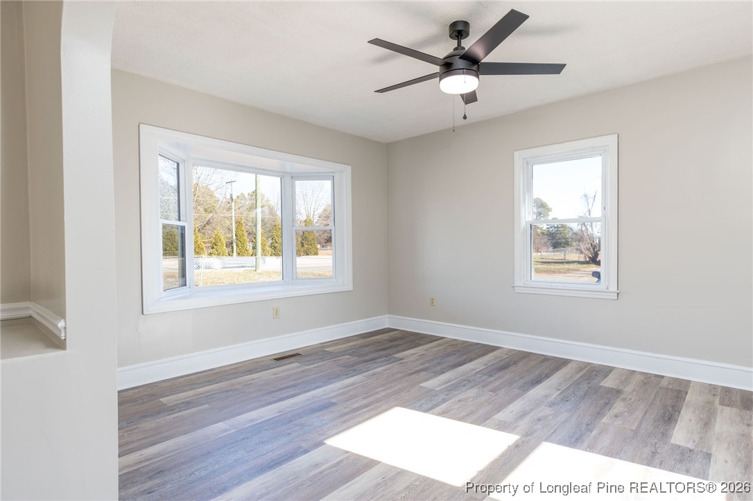 6341 Cliffdale Road Fayetteville, NC 28314 - Photo 6 of 20 a view of a livingroom with a window and wooden floor