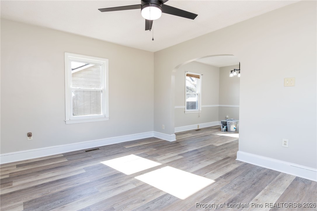 6341 Cliffdale Road Fayetteville, NC 28314 - Photo 7 of 20 a view of empty room with wooden floor and fan