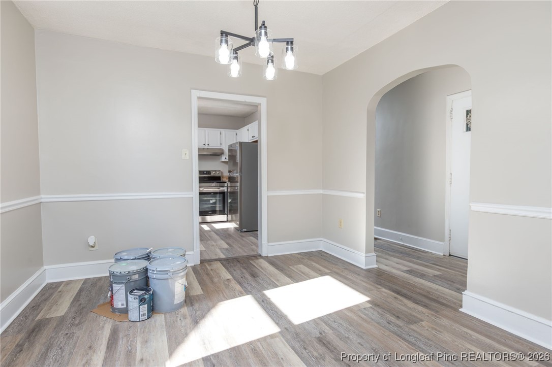6341 Cliffdale Road Fayetteville, NC 28314 - Photo 9 of 20 wooden floor in an empty room with a window