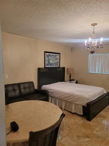 a bedroom with two beds and a chandelier